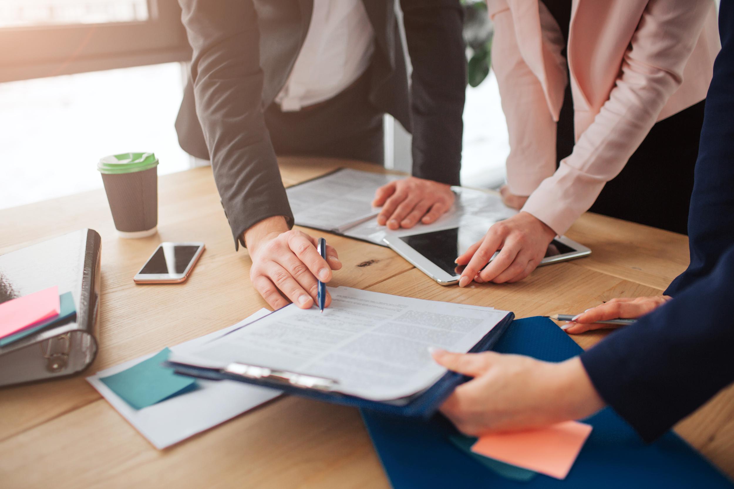11eb 90bd people working together table room